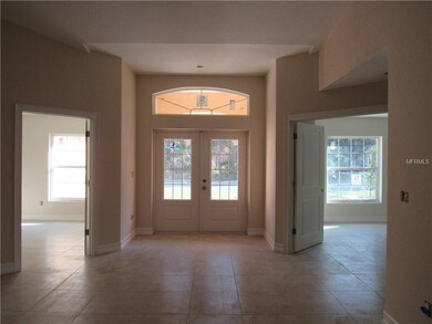 Standing in living room looking at front entry way