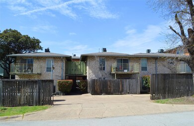 View of front of home featuring fence and a balco