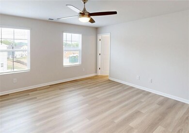 Unfurnished room with light wood-type flooring, ceiling fan, and baseboards