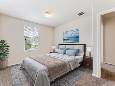 Bedroom featuring dark carpet