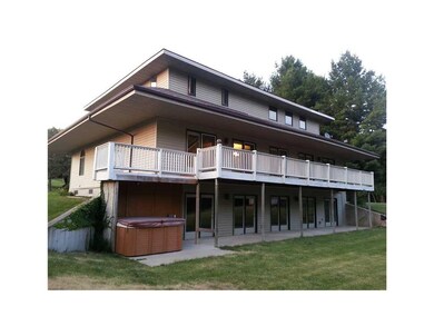 Exterior Back. Shows huge deck and patio and hot t