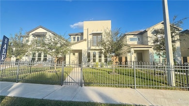 View of front of house with stucco siding, a fenced front yard, and a gate