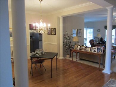 Formal Dining Room with hardwood floors, crown mol