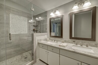 PRIMARY BATH: Double sinks, modern fixtures throug