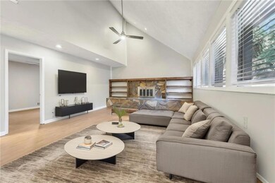 Living room featuring LVP / wood-style floors, hig