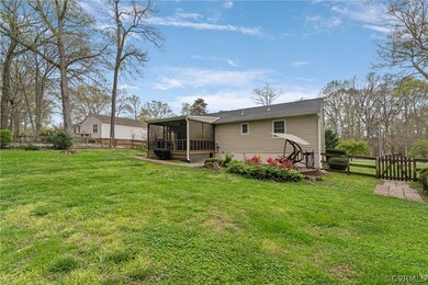 Back of house featuring a sunroom and a lawn
