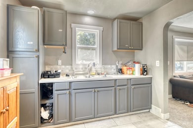 Kitchen featuring gray cabinets, light countertops, and light tile patterned flooring