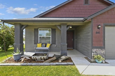 View of front of home featuring covered porch and stone siding