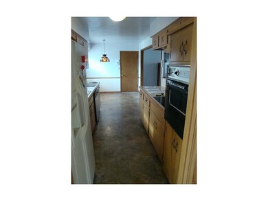 Looking thru galley kitchen to interior door to ga
