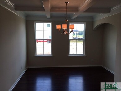 Formal dining with coffered ceiling and a custom s