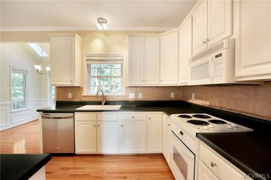 Lovely kitchen with eat in area. Hardwood flooring