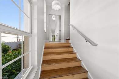 Stairway featuring a chandelier and a high ceiling