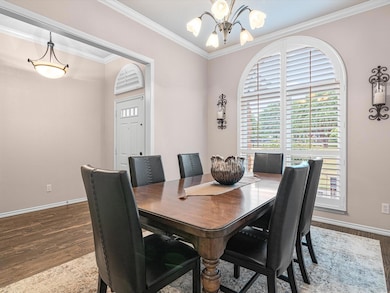 Dining area with ornamental molding, an inviting c