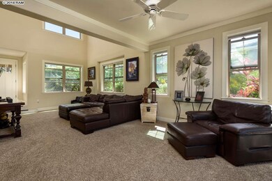 Light-filled two-story living room with windows on