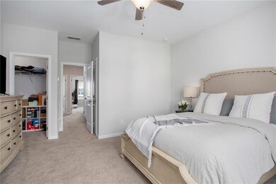Bedroom featuring a closet, ceiling fan, a spaciou