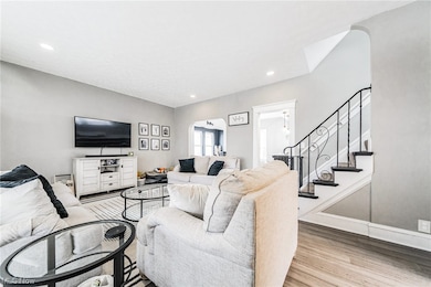 Living room with light hardwood / wood-style flooring