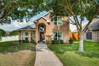 Nestled under towering trees on the corner of a quiet double cul-de-sac in Plano ISD