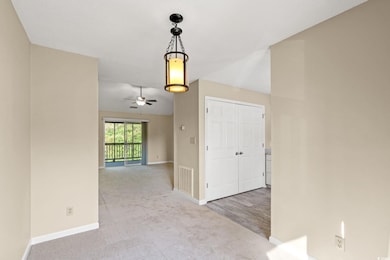 Hall with baseboards, carpet flooring, and lofted 