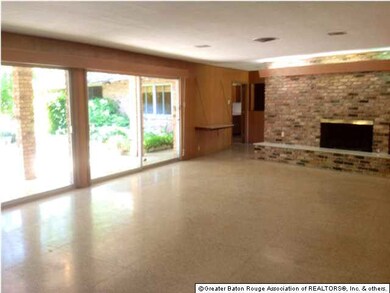 Living room with fireplace and a wall of glass