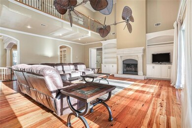 Great room features gas fireplace and heart pine f