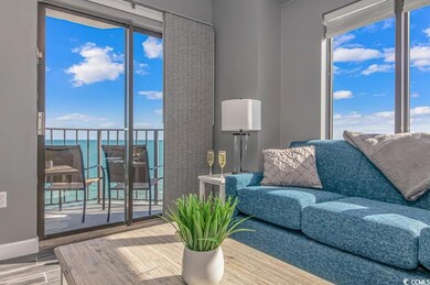 Living area featuring a water view, healthy amount of natural light, and wood finished floors