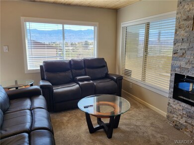 Carpeted living room featuring plenty of natural l