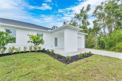 View of side of home featuring a lawn, stucco sidi