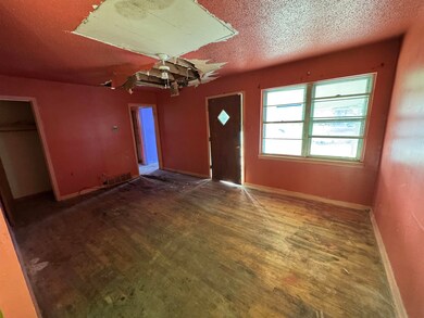 Foyer with a textured ceiling and dark wood-type f