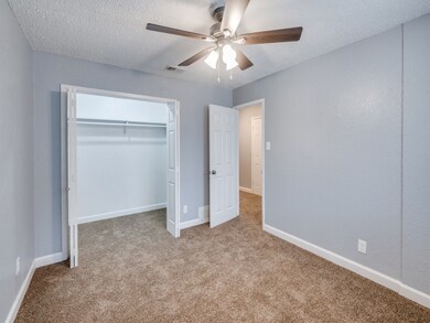 Unfurnished bedroom with carpet floors, ceiling fan, a textured ceiling, and a closet
