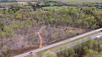 Birds eye view of property featuring a wooded view