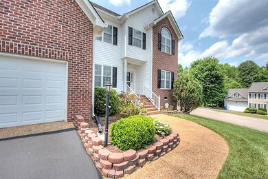 Freshly paved drive leads to 2 car garage.