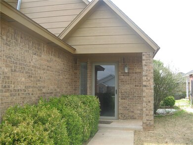 Entry with covered porch, brick column and storm d
