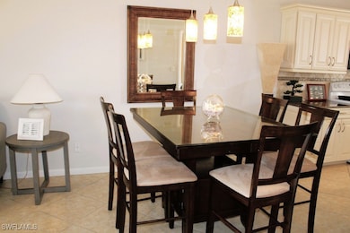 Dining room with light tile patterned flooring and baseboards