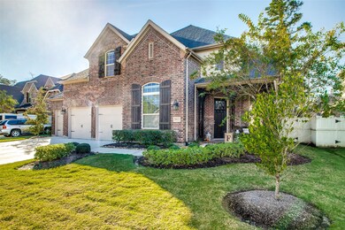 A view of the entrance to the home.  Home offers accent shutters and guttering system.