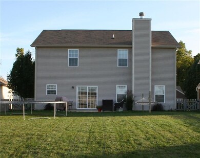 Back of the home...sliding glass doors lead to the breakfast room/kitchen. Notice the gates on both sides of the home. 