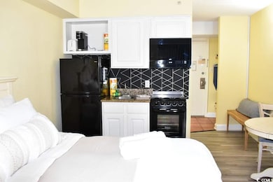 Kitchen featuring black appliances, hardwood / woo