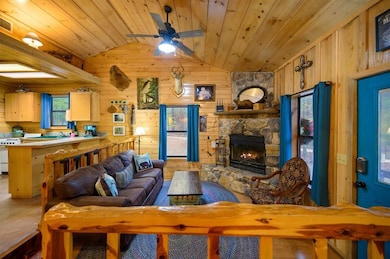 Living room with a fireplace, wood ceiling, wooden