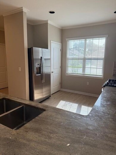 Kitchen featuring refrigerator with ice dispenser