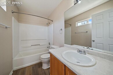 Full bath featuring toilet, wood finished floors, vanity, and washtub / shower combination