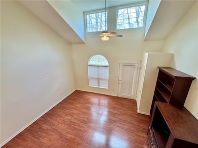 Open living room with vaulted ceilings greet you.