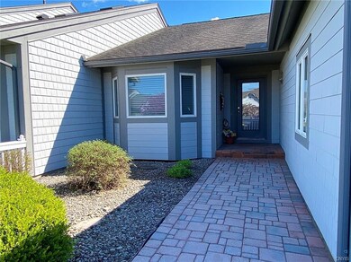 A beautiful paver walkway and open patio greet you