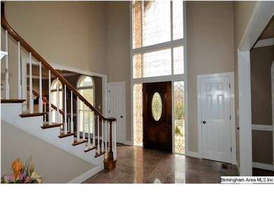 Entry with towering, stain glass windows.