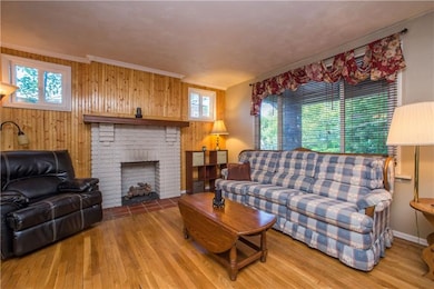 The decorative brick fireplace is flanked by windo