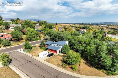 Birds eye view of property with trees in the back 