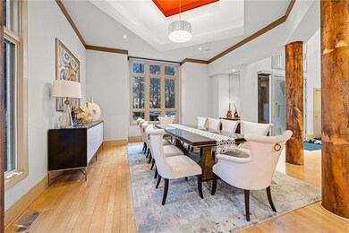 Dining area featuring a raised ceiling, light wood finished floors, ornamental molding, baseboards, and recessed lighting