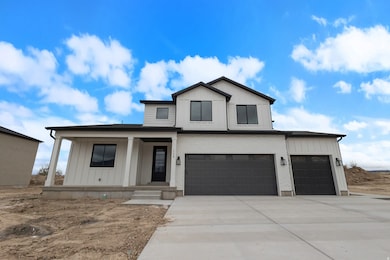 Modern farmhouse style home with covered porch, concrete driveway, an attached garage, and board and batten siding