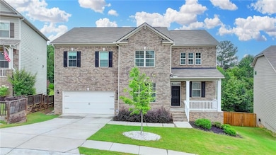 View of front of home with brick siding, a porch, concrete driveway, an attached garage, and a shingled roof