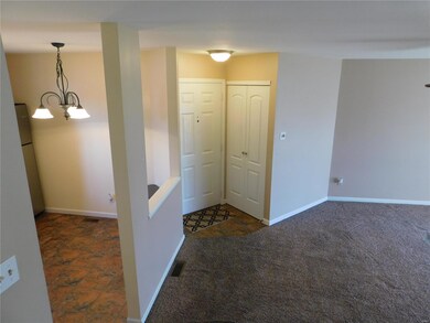 A view of the foyer, coat closet and entrance to t