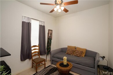 Living room with light tile flooring and ceiling fan