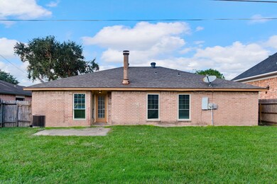 Single-story brick home featuring a modest backyar